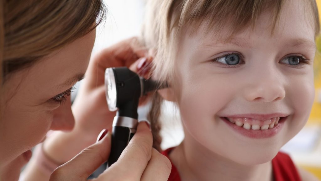 Child getting there ear checked.